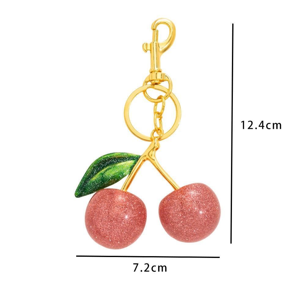 Petite Pink Cherry Keyring matched with a single green leaf view 2